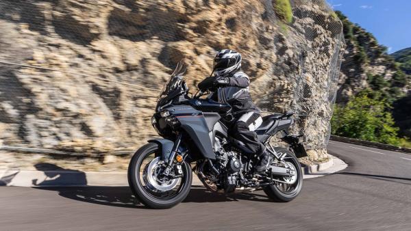 The Tracer 9 GT being ridden on a mountain road