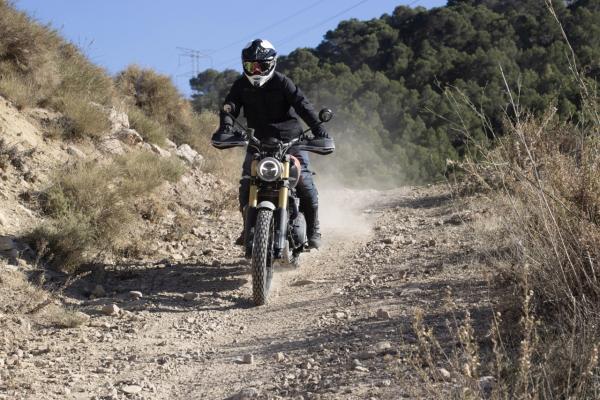 A Scrambler motorbike being ridden off-road