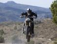 A Triumph motorbike being jumped through the air