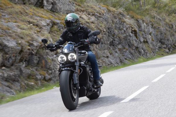 A motorcycle being along a canyon road