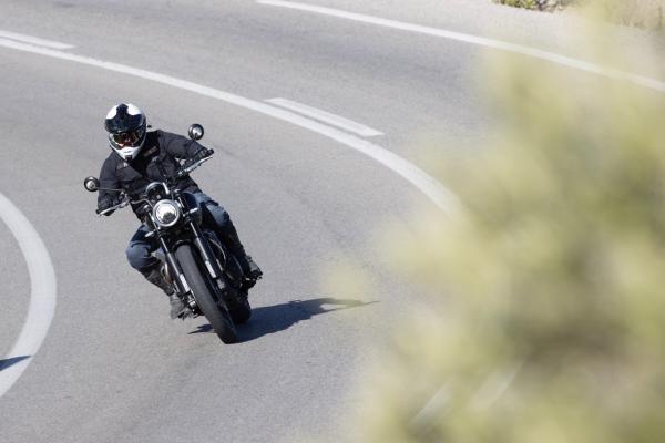 A motorcycle being ridden around a bend in the road