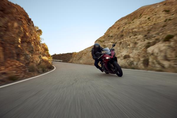 A sport bike being ridden down a canyon road