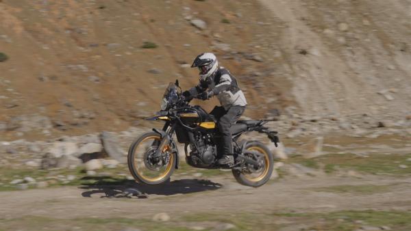 A motorcycle jumping off a rock on an off-road trail