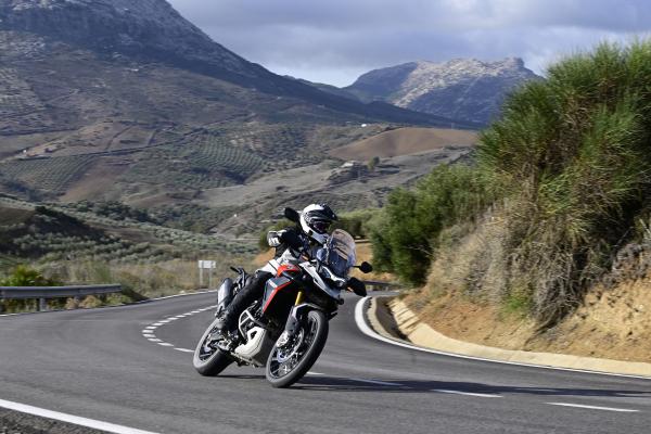 A motorcycle being ridden around a bend in the road